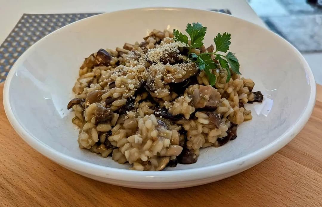 This rich and creamy vegan mushroom risotto combines Arborio rice, a medley of dried and fresh mushrooms, white wine, and vegetable stock, all brought together with a touch of vegan butter and parmesan.